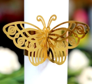 Close-up of golden hollow 3D butterfly napkin ring with laser-cut metallic finish