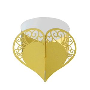 Macro detail of laser-cut heart pattern on golden cardstock napkin ring for weddings