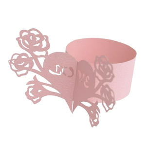 Detailed laser cut pink paper napkin ring with floral heart patterns and Love cutout