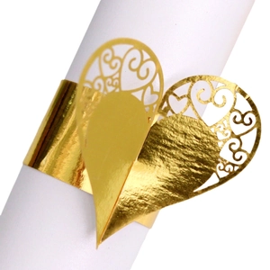 Gold laser-cut paper napkin rings with heart and vine patterns for wedding table decor