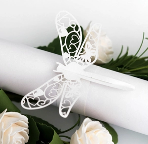 Detailed laser-cut white paper dragonfly napkin ring with delicate floral镂空 patterns