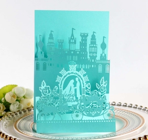 Macro view of laser-cut 3D wedding invitation featuring a romantic pumpkin carriage