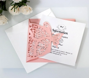 Detailed view of pink laser-cut butterfly wedding invitation with envelope and card