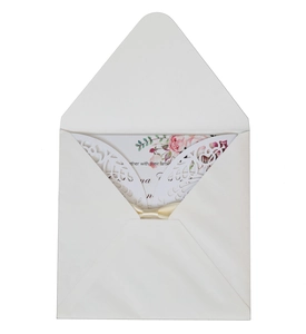 Elegant white laser-cut wedding invitation featuring floral card and champagne silk bow
