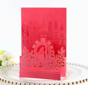Detailed laser-cut 3D wedding invitation featuring a red castle and carriage design