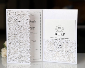 Detailed laser-cut lace wedding invitation and RSVP card set with elegant vine patterns