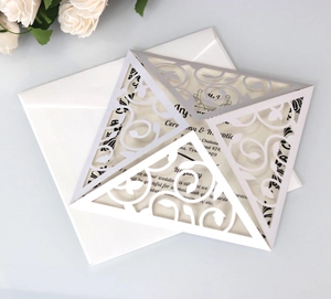 Elegant laser cut wedding invitation set with ornate scrollwork and pearl paper texture