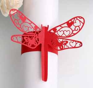 Detail showing the laser-cut dragonfly napkin ring made of elegant red pearlescent paper