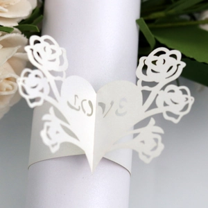 Detailed laser cut white pearlescent paper napkin ring with LOVE heart and rose patterns