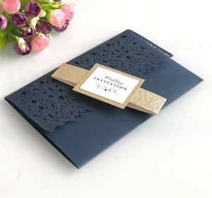 Elegant navy blue laser-cut wedding invitation with gold glitter belly band and floral pattern