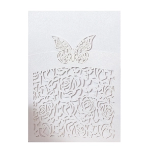 Detail of white laser-cut wedding invitation with rose pattern and butterfly