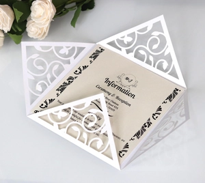 Laser cut white floral wedding invitation with cream insert and elegant roses