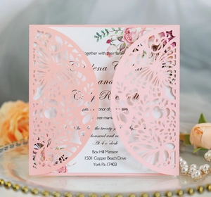 Detail of pink laser-cut butterfly wedding invitation with elegant floral inner card