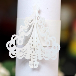Laser cut white Christmas tree paper napkin ring with intricate hollowed star pattern