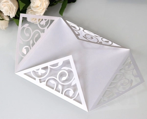 Elegant white laser-cut floral invitation card with intricate vine patterns for weddings