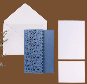 Detailed laser-cut floral invitation set in deep blue with envelopes and insert cards