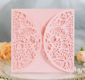 Detail of pink laser-cut floral and butterfly invitation card with premium matte texture