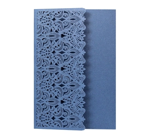 Macro view of laser-cut invitation sleeve in navy blue with elegant glitter finish