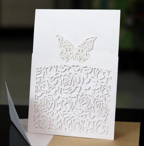 Detailed laser-cut white rose wedding invitation with pearl shimmer and lace butterfly