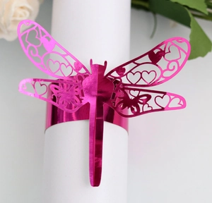 Detail showing laser cut dragonfly napkin ring with heart patterns in vibrant magenta