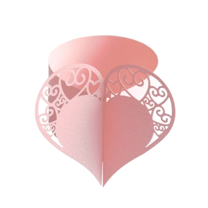 Detail of pink laser-cut heart napkin rings with pearlescent finish for wedding decor