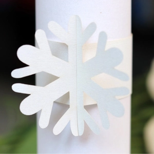 Elegant white snowflake paper napkin ring with laser-cut design for festive table decor