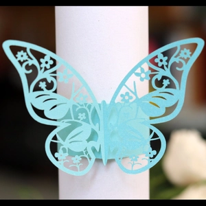Elegant light blue laser-cut butterfly napkin ring with intricate hollow floral patterns