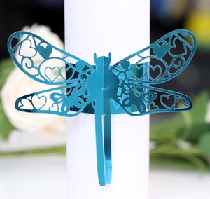 Detailed laser-cut dragonfly napkin ring with hollow heart pattern in metallic blue