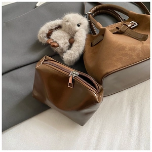 Deep brown bucket bag with matching zipper pouch and cute plush rabbit charm detail