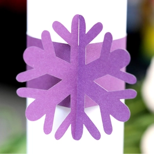 Purple snowflake paper napkin ring holder with laser-cut design for festive table decor