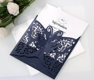 Detail of laser-cut butterfly wedding invitation in navy blue glitter cardstock