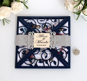 Macro view of navy laser cut wedding invitation with silver glitter band and floral liner