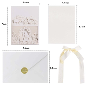 Elegant white laser-cut wedding invitation suite with romantic carriage design and ribbon