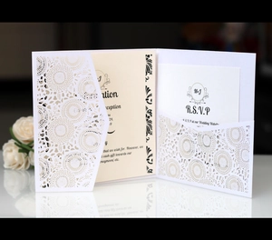 Detail of laser-cut floral wedding invitation with custom MJ monogram and RSVP insert