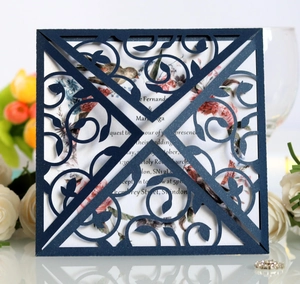 Detail of laser-cut navy wedding invitation with floral inner card and tulip decor