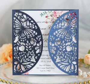 Detail showing navy blue laser-cut wedding invitation with rose floral card and pearls
