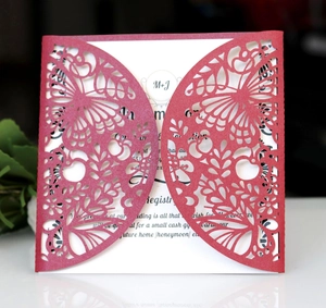 Detail of laser-cut red butterfly pattern wedding invitation with white insert card