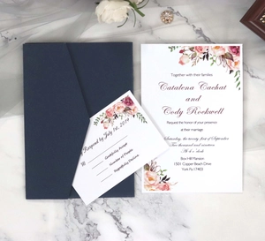 Navy wedding invitation set with floral design and RSVP card on white marble