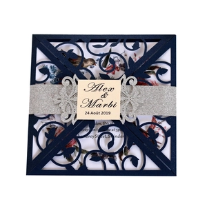 Elegant navy blue laser-cut wedding invitation with glitter belly band and floral insert