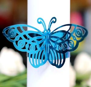 Detail showing the intricate laser-cut butterfly napkin ring in bright royal blue