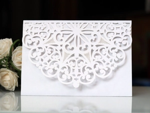 Elegant white laser-cut mandala wedding invitation with a pearlescent finish and floral decor
