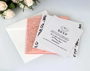 Detail of laser-cut wedding invitation set with floral cover and white RSVP card