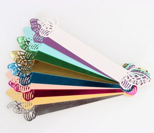 Detail of laser-cut butterfly napkin rings in ten assorted metallic colors on white