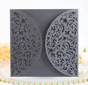 Detail showing elegant black laser-cut floral pattern on a square wedding invitation