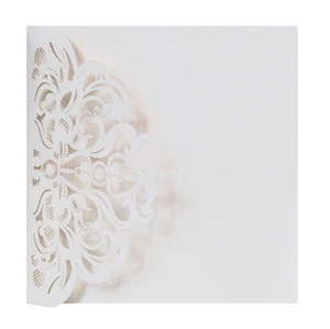 Detail of white laser cut invitation card showing intricate floral lace patterns