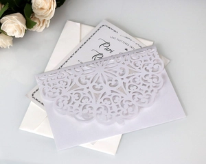 Elegant white laser-cut wedding invitation featuring mandala floral hollow lace and card
