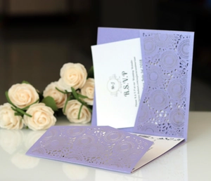 Detailed laser-cut purple floral pattern on a formal wedding invitation with RSVP card