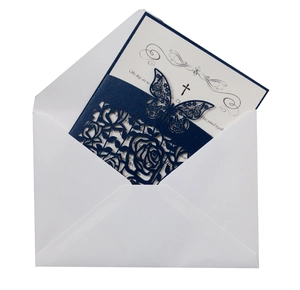 Detail of laser-cut navy blue butterfly invitation with white insert card and envelope