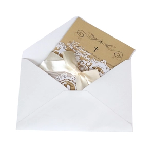 Close-up of laser-cut wedding invitation with carriage design and beige satin bow