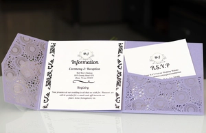 Detail of purple laser-cut wedding invitation with elegant hollow patterns and RSVP cards